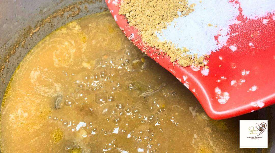 Adding seasoning to oil less okro soup